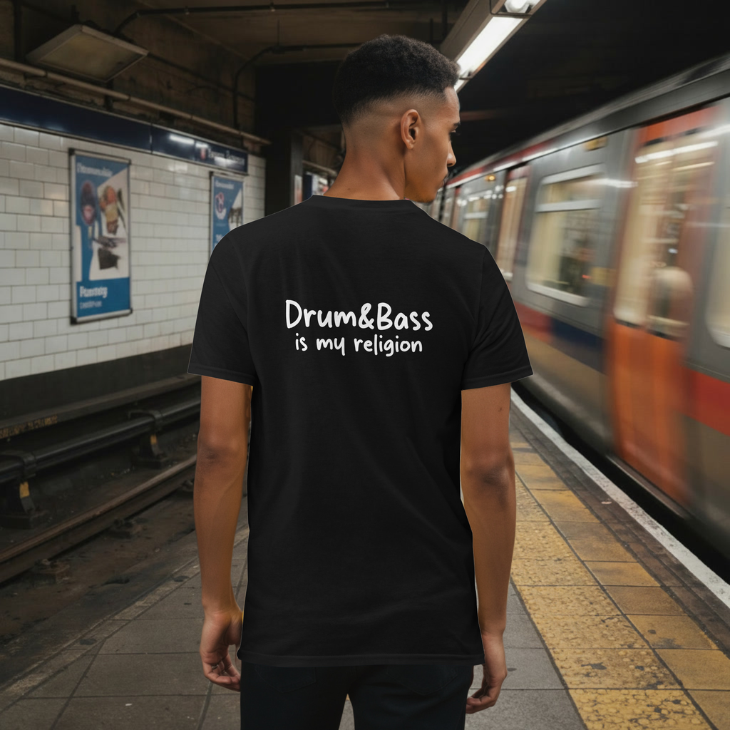 Model wearing a Unisex t-shirt with bold, geometric Funky Jaysus illustration on the front and “Drum & Bass is my religion” slogan on the back. A statement piece for DnB fans and streetwear lovers.