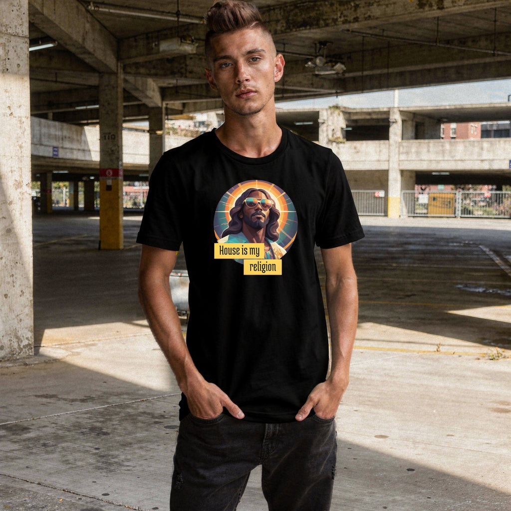 A person wearing a black t-shirt with a graphic design of Funky Jaysus with the wording 'House is my religion' in an empty car park.