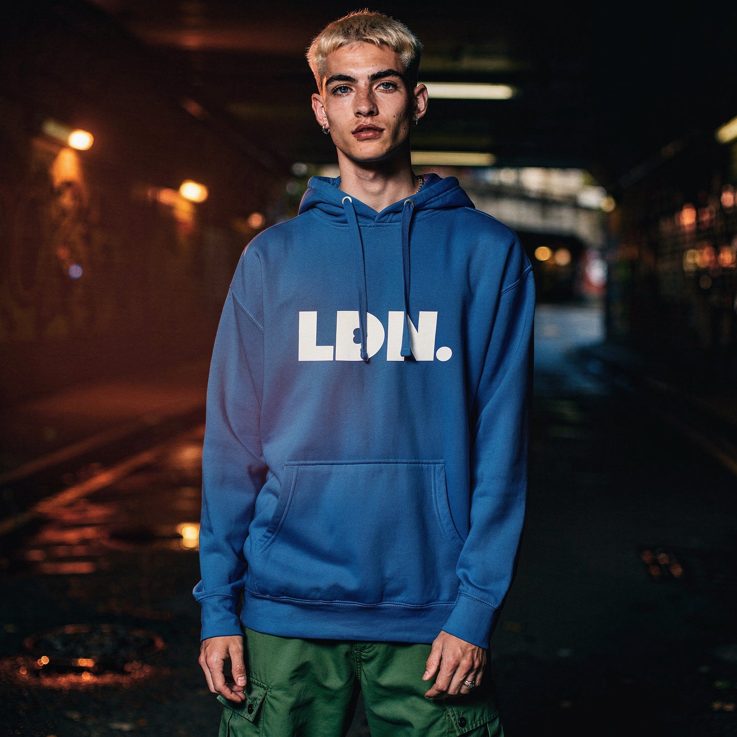 Unisex Hoodie - Blue hoodie with white “LDN.” graphic worn by female model — soft fleece lining, relaxed streetwear silhouette, perfect for layering in cooler seasons.
