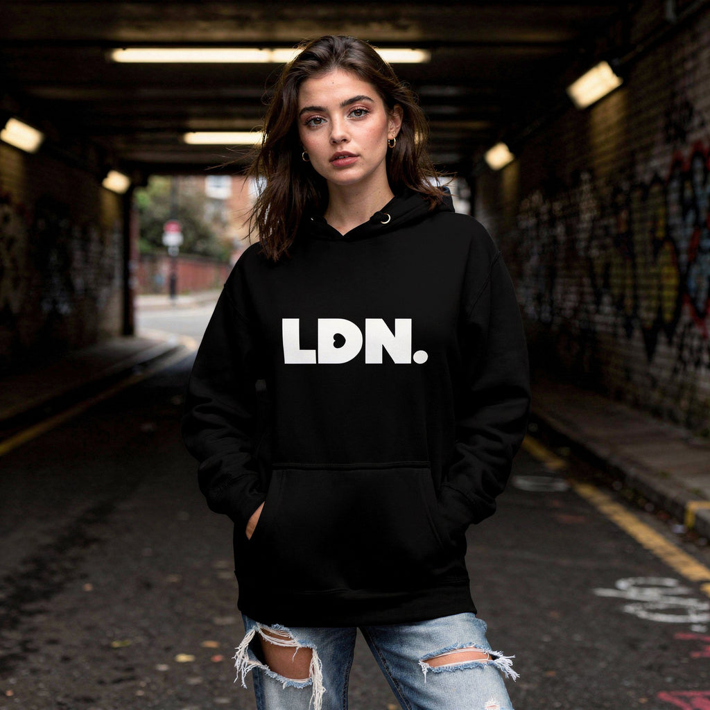 Unisex Hoodie - Black hoodie with white “LDN.” graphic worn by female model — soft fleece lining, relaxed streetwear silhouette, perfect for layering in cooler seasons.