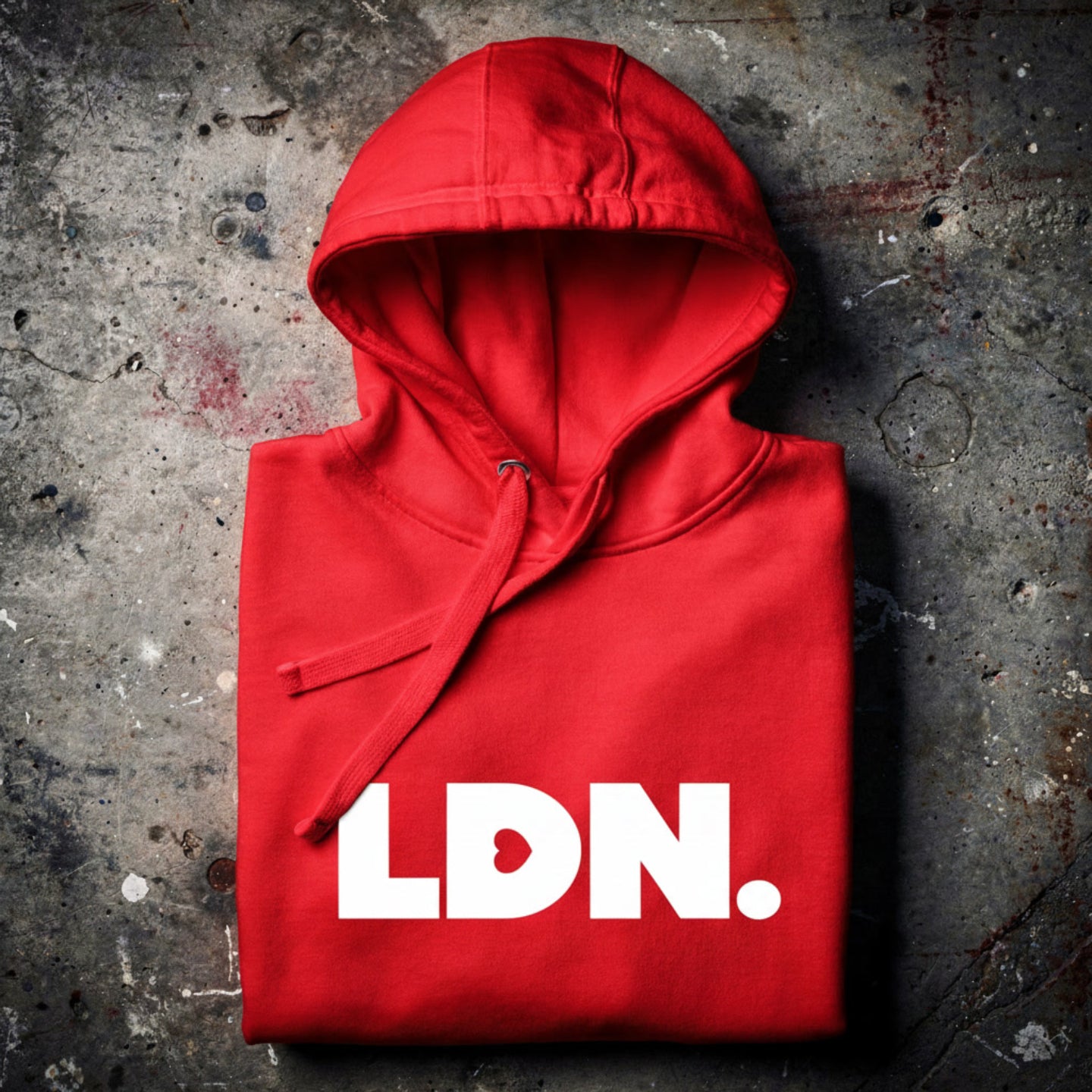 Unisex Hoodie - Red hoodie with white “LDN.” graphic worn by female model — soft fleece lining, relaxed streetwear silhouette, perfect for layering in cooler seasons.