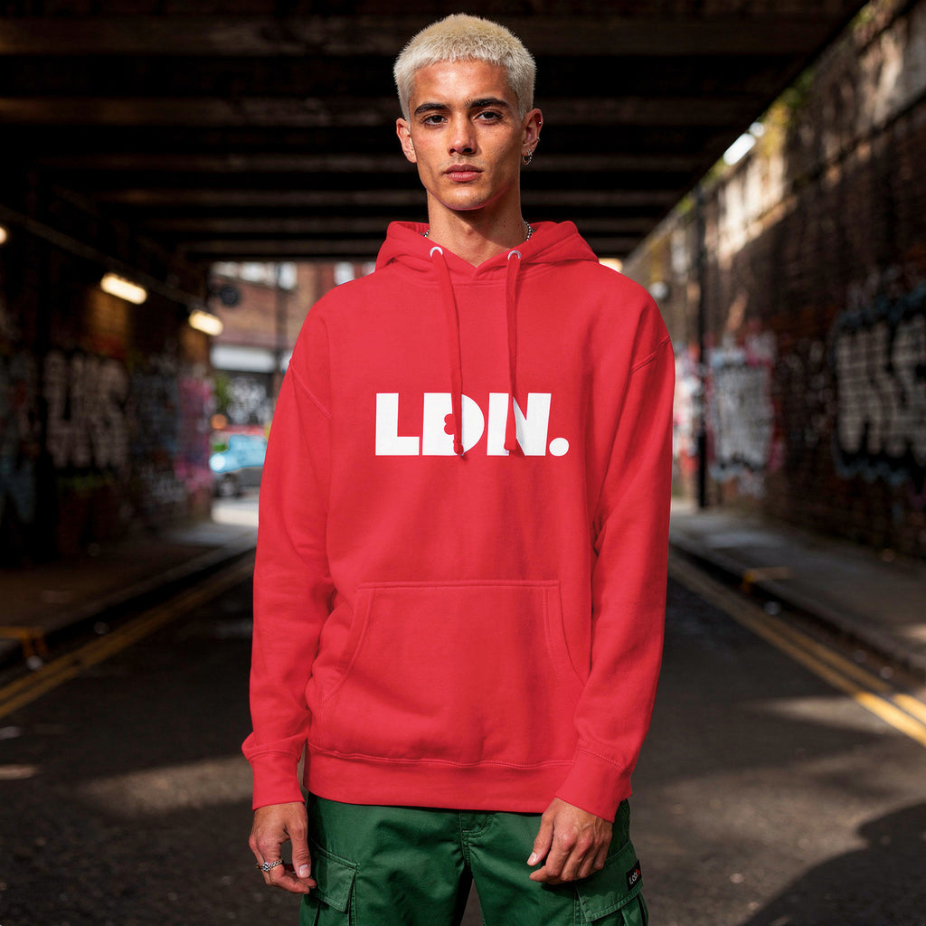 Unisex Hoodie - Red hoodie with white “LDN.” graphic worn by female model — soft fleece lining, relaxed streetwear silhouette, perfect for layering in cooler seasons.