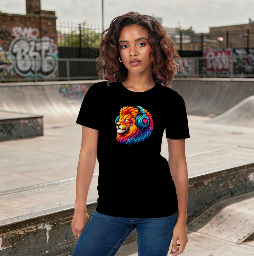 Person wearing a t-shirt with a colourful lion graphic, standing in a skateboard park