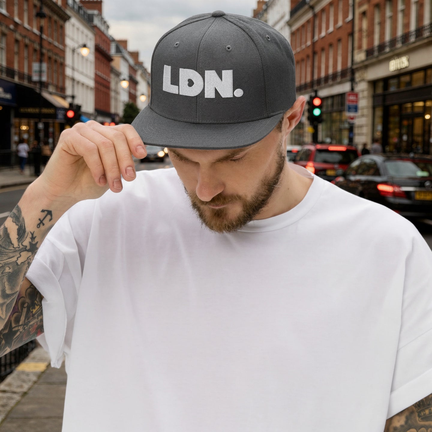 Dark Grey snapback hat featuring bold “LDN.” text in white — streetwear-ready with structured fit, flat brim, and adjustable back. A sharp urban essential for London lovers.