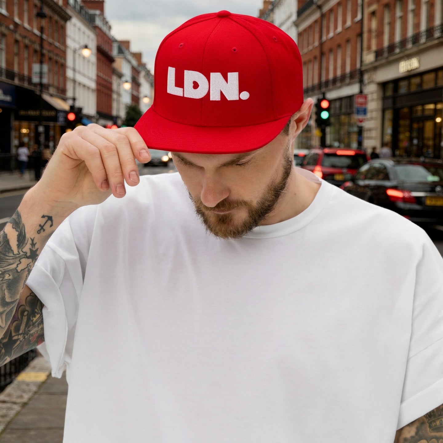 Red snapback hat featuring bold “LDN.” text in white — streetwear-ready with structured fit, flat brim, and adjustable back. A sharp urban essential for London lovers.
