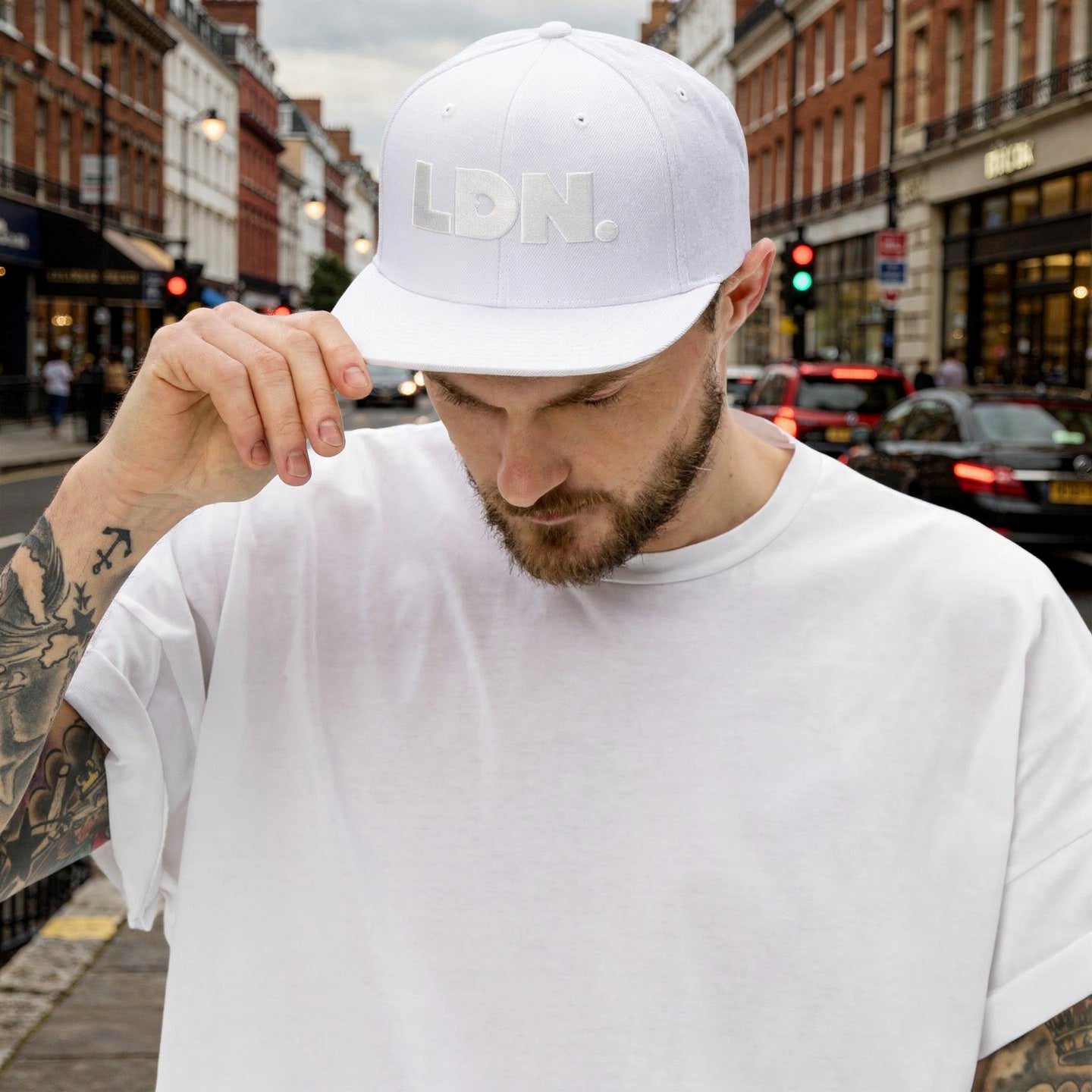 White snapback hat featuring bold “LDN.” text in white — streetwear-ready with structured fit, flat brim, and adjustable back. A sharp urban essential for London lovers.