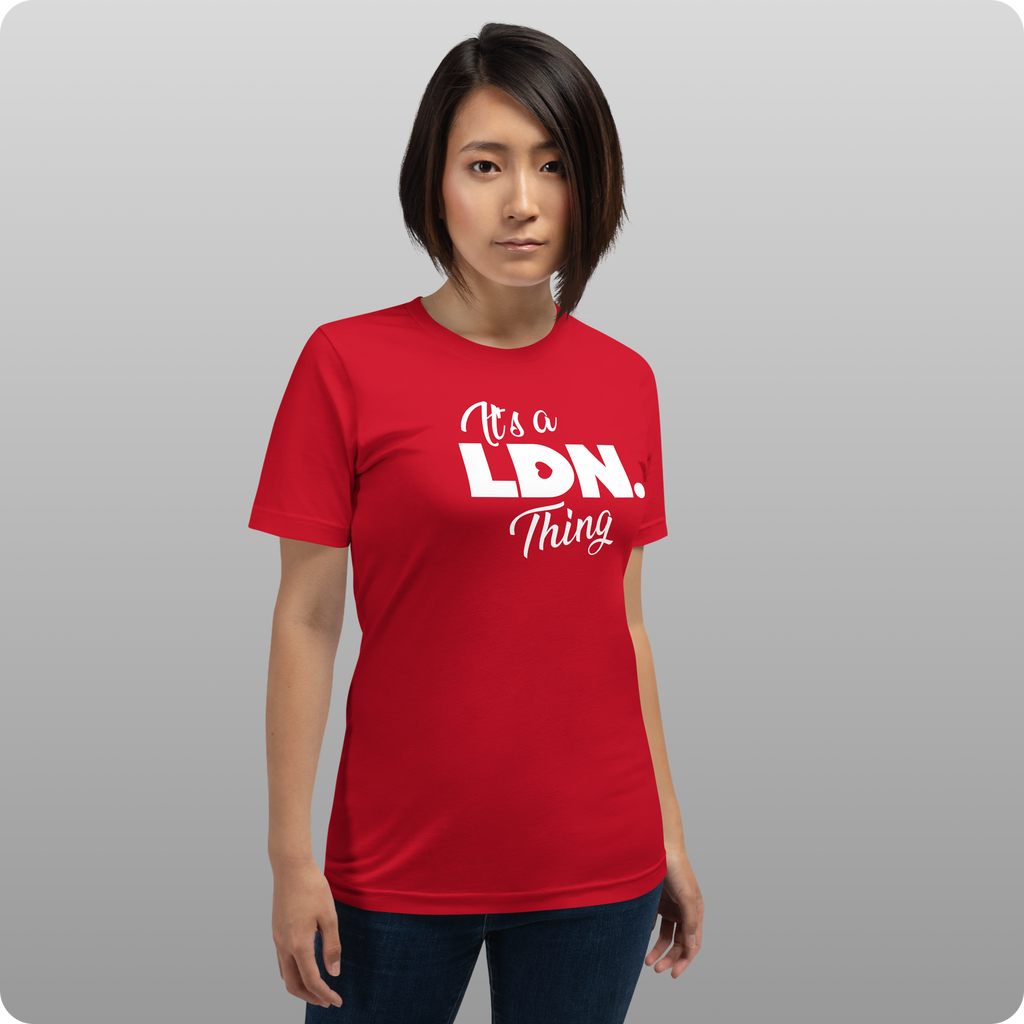 Person wearing a red t-shirt with text on a gray background