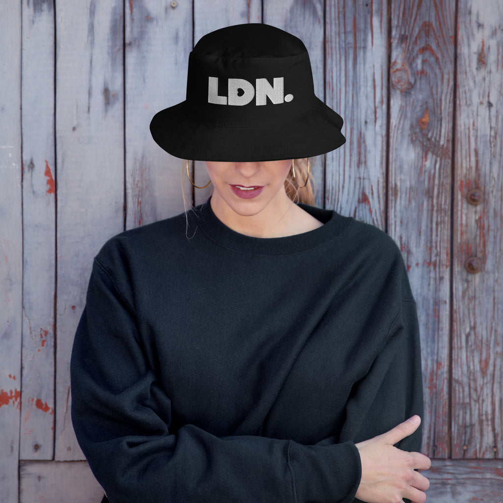 Bucket hat with bold embroidered LDN. logo on front. Features cotton twill fabric, breathable eyelets, and a relaxed wide brim. Ideal for everyday streetwear, summer outfits, or repping London in casual style.