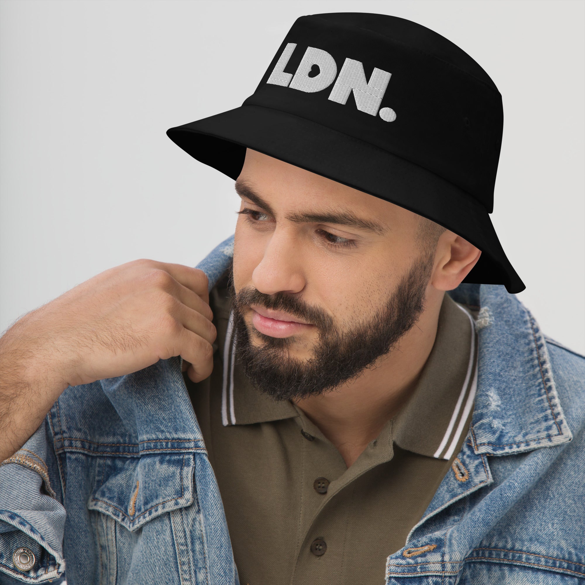 Bucket hat with bold embroidered LDN. logo on front. Features cotton twill fabric, breathable eyelets, and a relaxed wide brim. Ideal for everyday streetwear, summer outfits, or repping London in casual style.