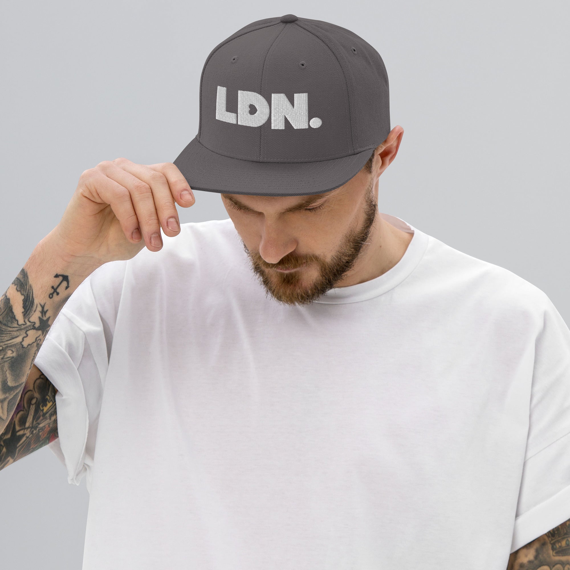 Black snapback hat featuring bold “LDN.” text in white — streetwear-ready with structured fit, flat brim, and adjustable back. A sharp urban essential for London lovers.
