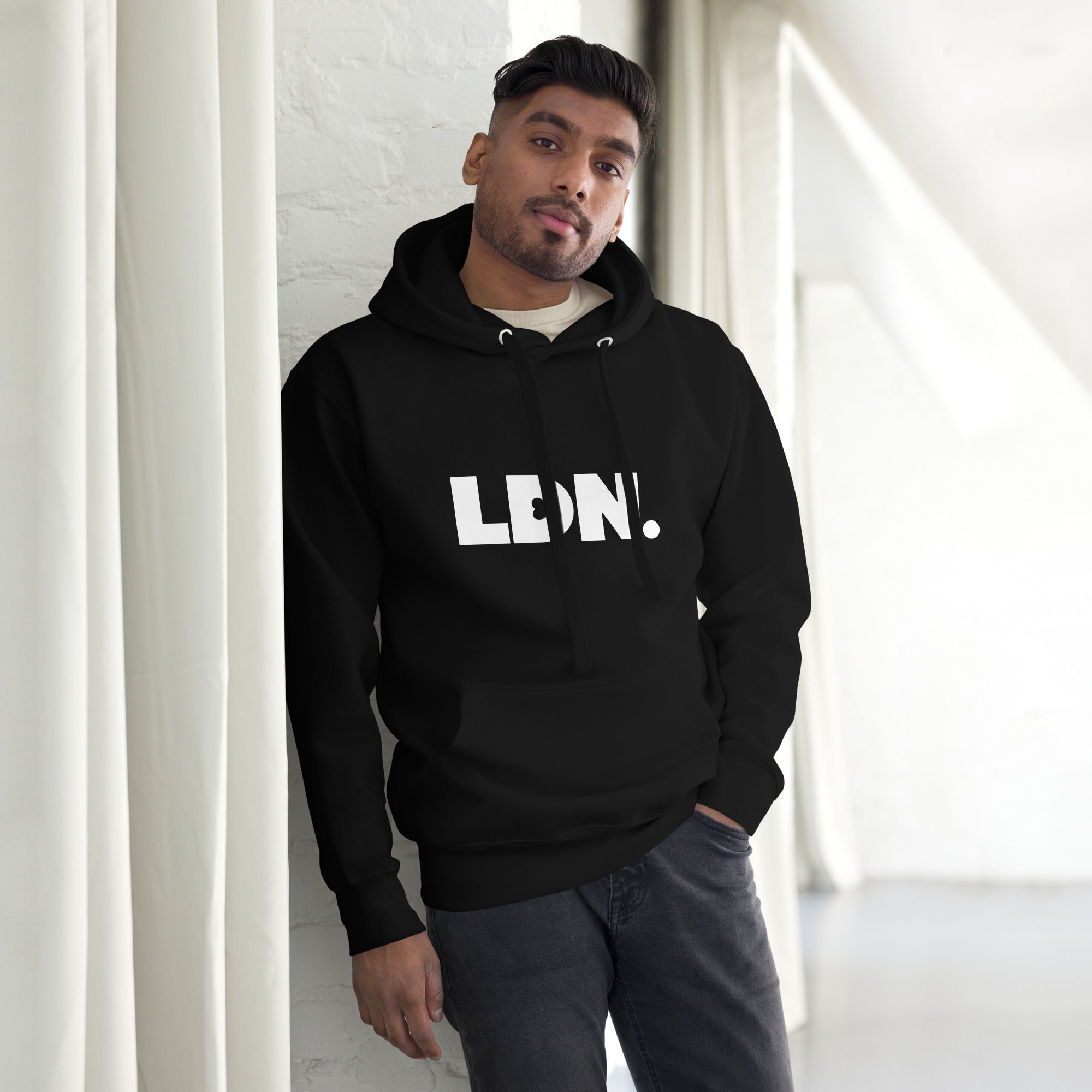 Unisex Hoodie - hoodie with white “LDN.” graphic worn by male model — soft fleece lining, relaxed streetwear silhouette, perfect for layering in cooler seasons.