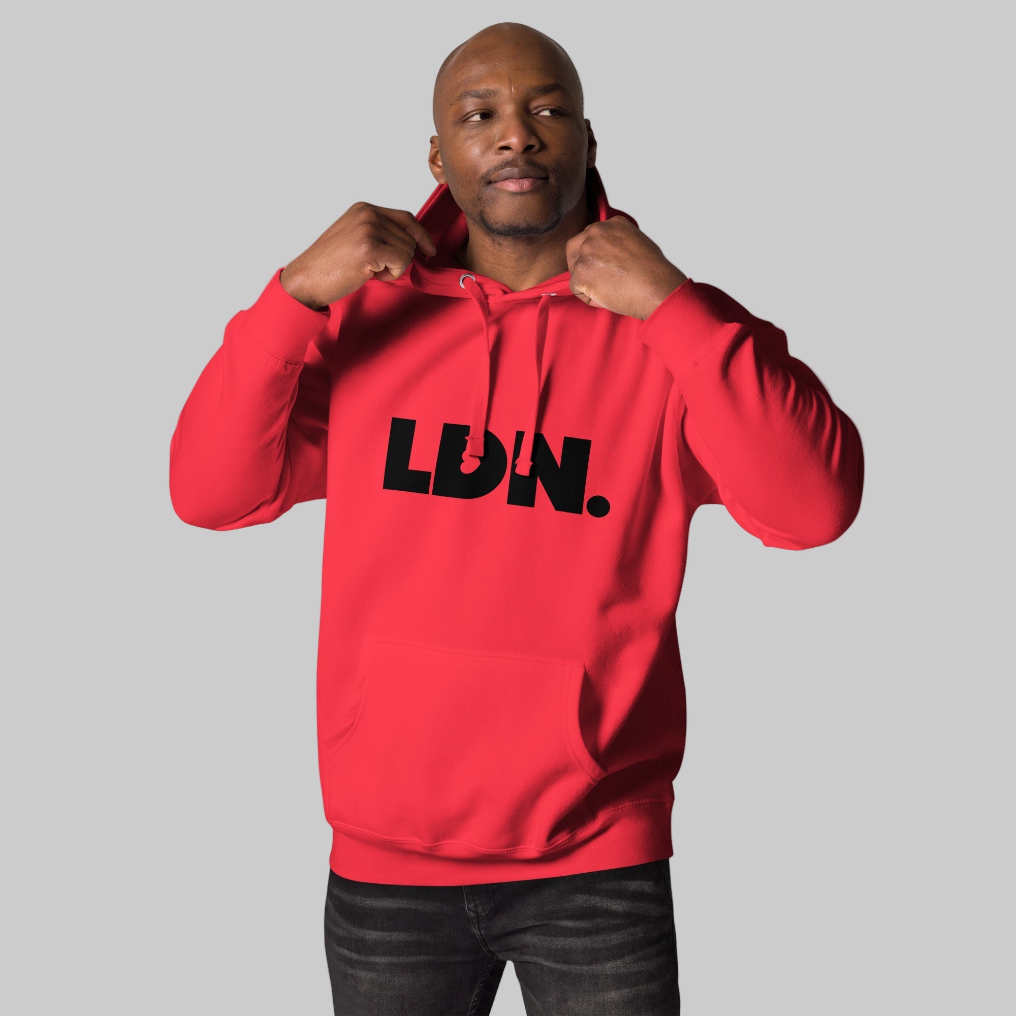Unisex Hoodie - Black hoodie with tonal “LDN.” graphic worn by male model — soft fleece lining, relaxed streetwear silhouette, perfect for layering in cooler seasons.