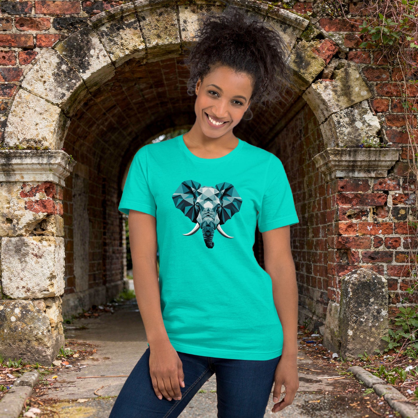 Model wearing t-shirt featuring a bold geometric elephant graphic. Clean animal design with sharp lines and modern streetwear styling, wearing ripped jeans, Ancient stone archway or crumbling brick wall.