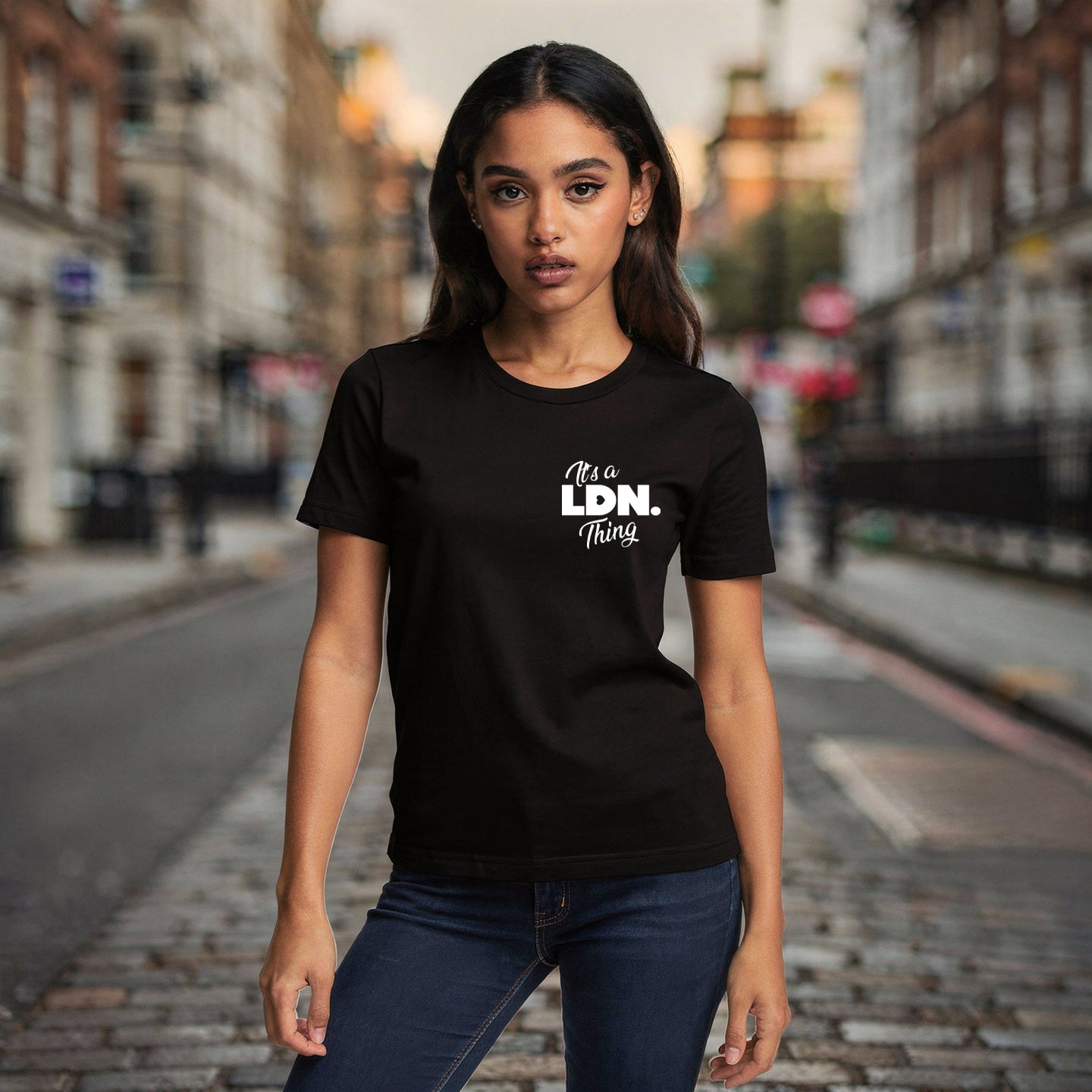 Woman wearing a black t-shirt with 'It's a Ldn. Thing' text on a city street.