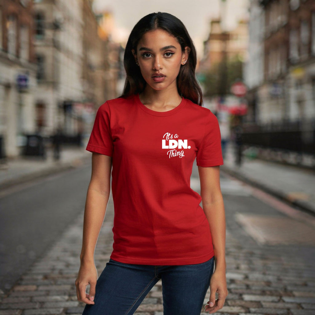 Woman wearing a red t-shirt with 'It's a Ldn. Thing' text on a city street.