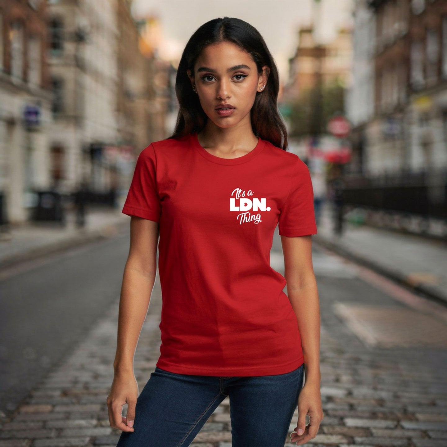 Woman wearing a red t-shirt with 'It's a Ldn. Thing' text on a city street.