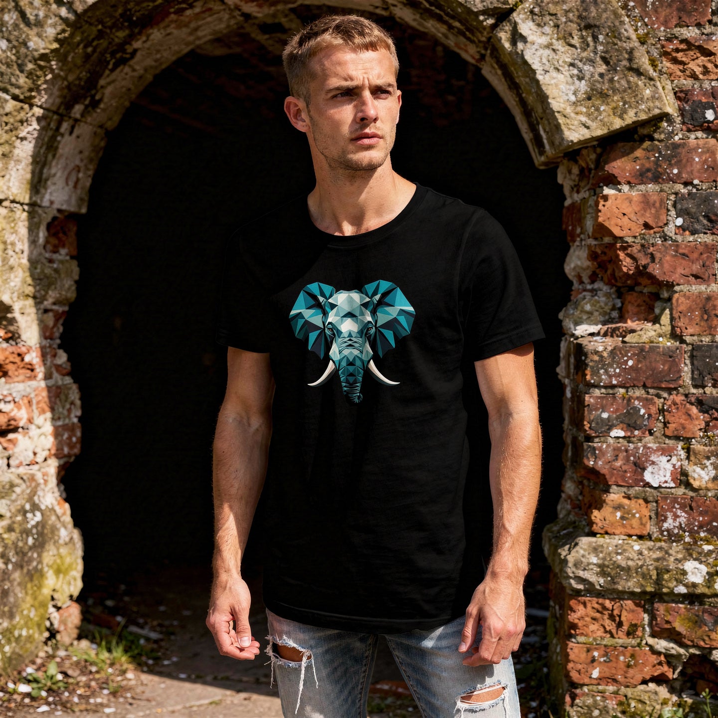 Unisex t-shirt featuring a bold geometric elephant graphic. Clean animal design with sharp lines and modern streetwear styling, wearing ripped jeans, Ancient stone archway or crumbling brick wall.
