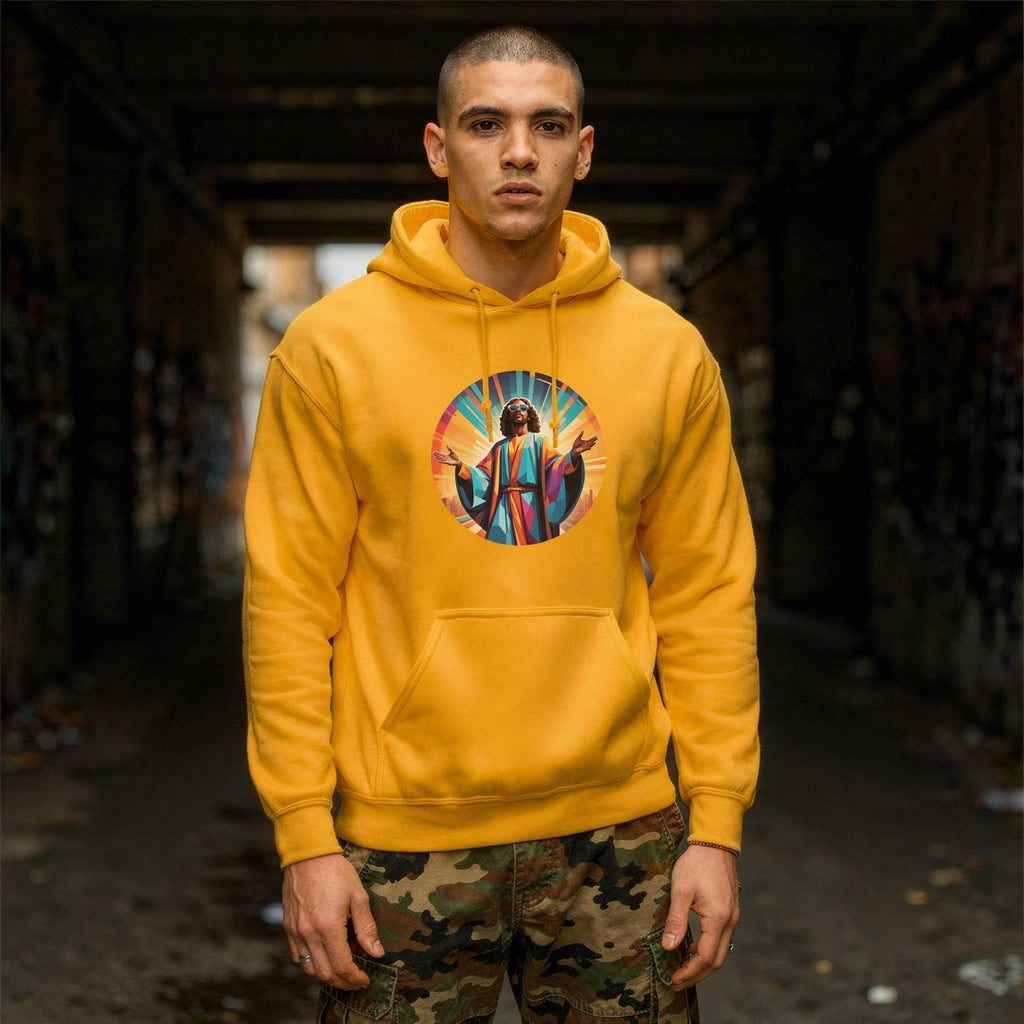 A man wearing a bright yellow hoodie with a colorful graphic of Jesus on the chest, standing in a dark, graffiti-covered alleyway.