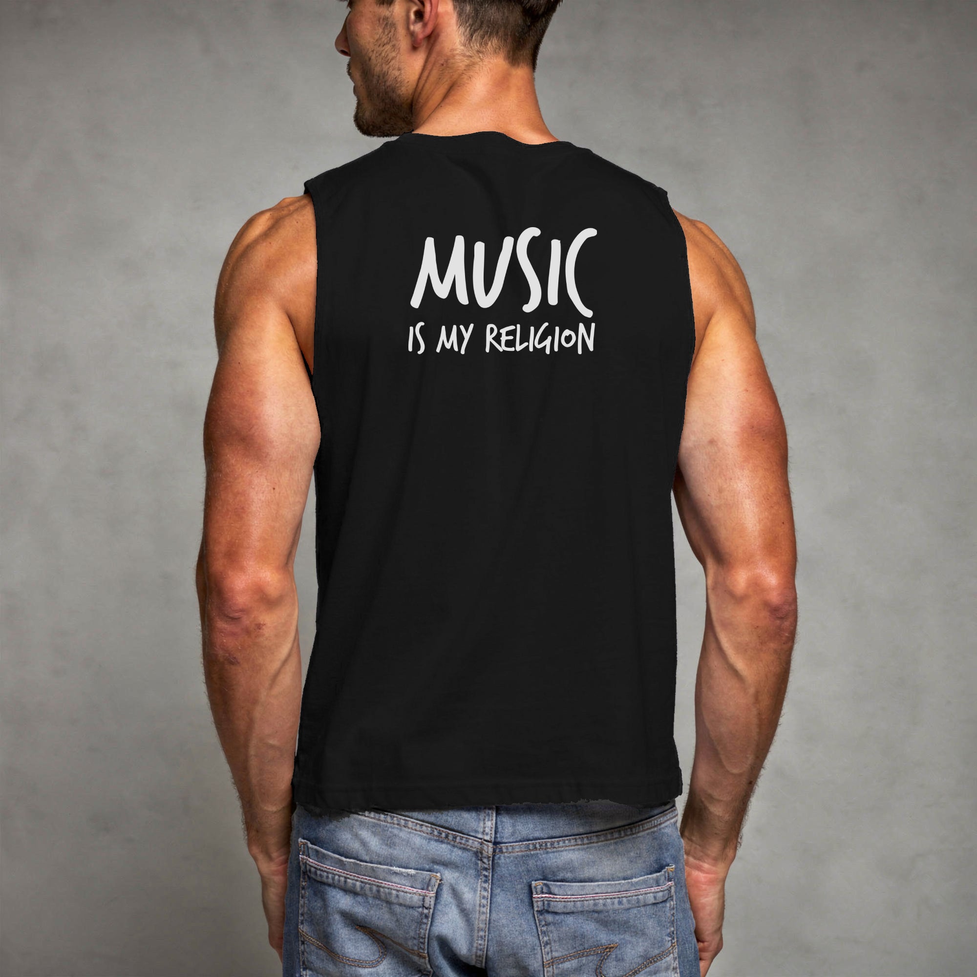 Male model wearing a black sleeveless shirt with 'MUSIC IS MY RELIGION' text on the back against a grey background