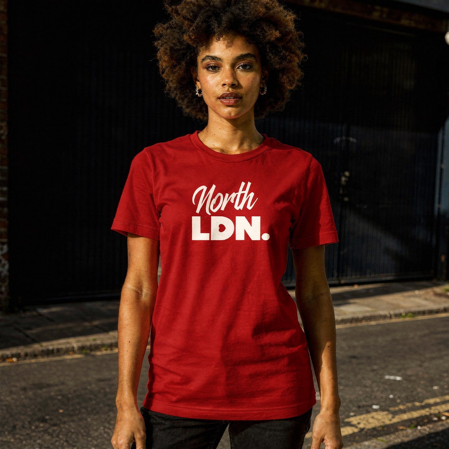 Person wearing a red t-shirt with 'North LDN' text on a dark background