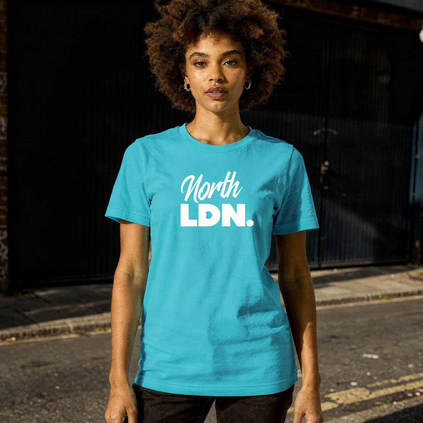Person wearing a blue 'North LDN' t-shirt standing on a street.