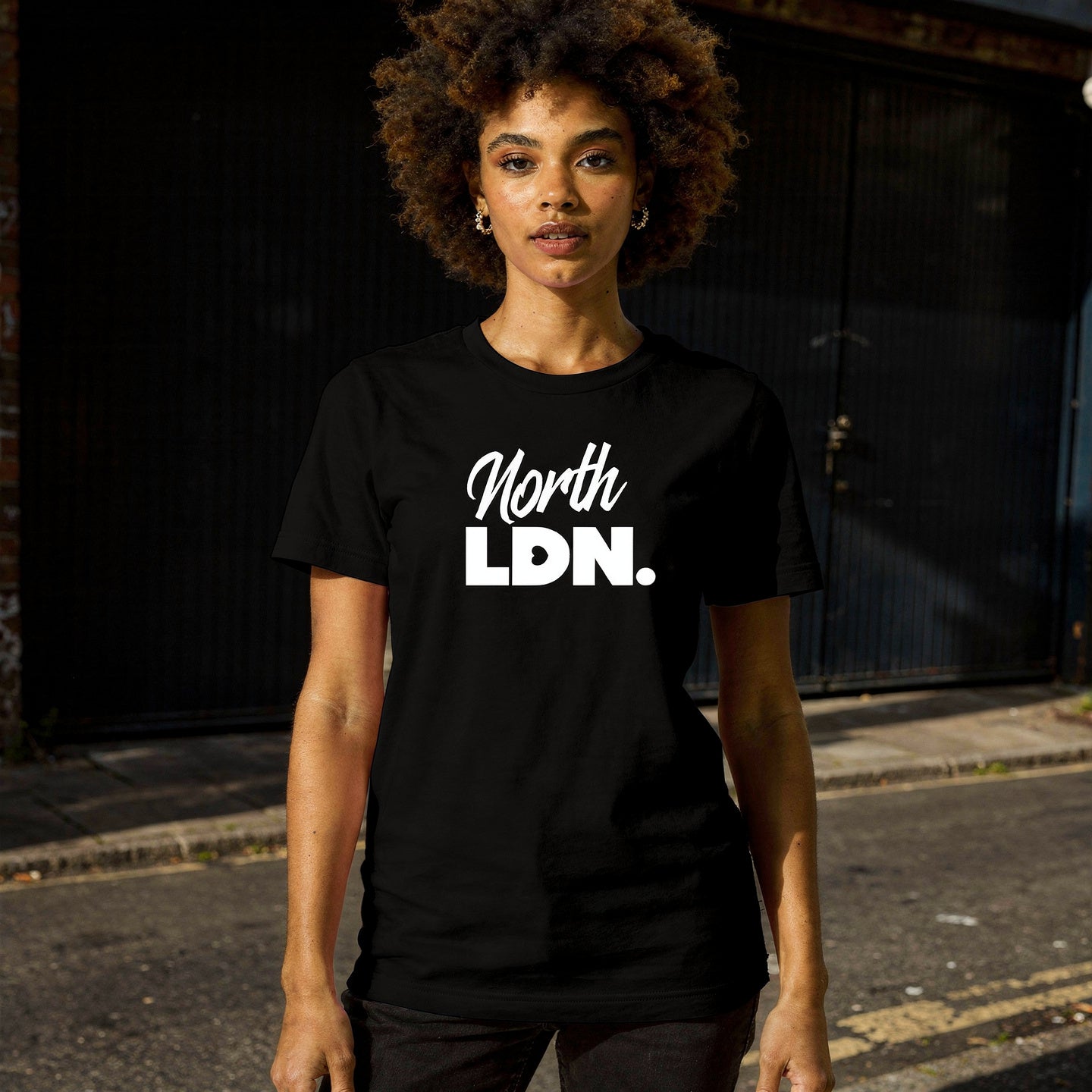 Person wearing a black t-shirt with 'North LDN' text on a street.
