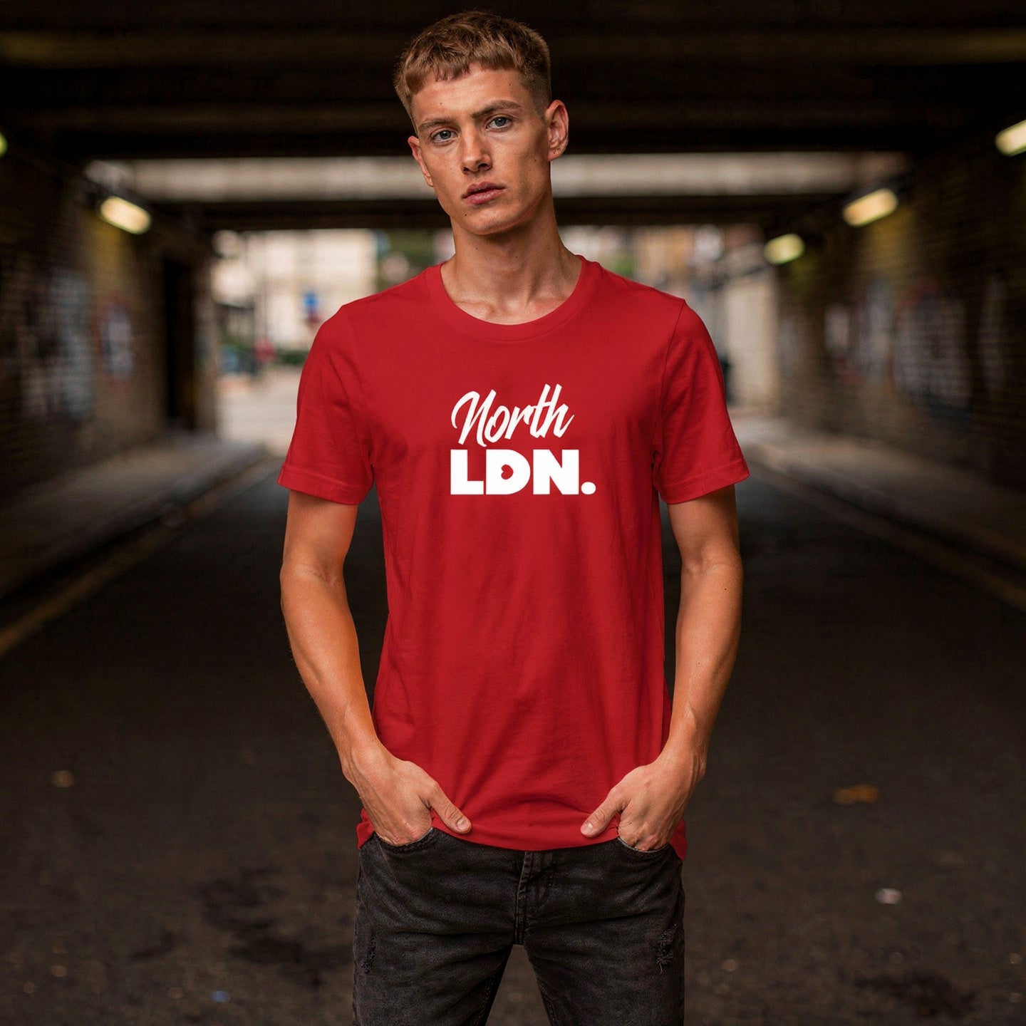 Person wearing a red t-shirt with 'North LDN' text in an urban setting