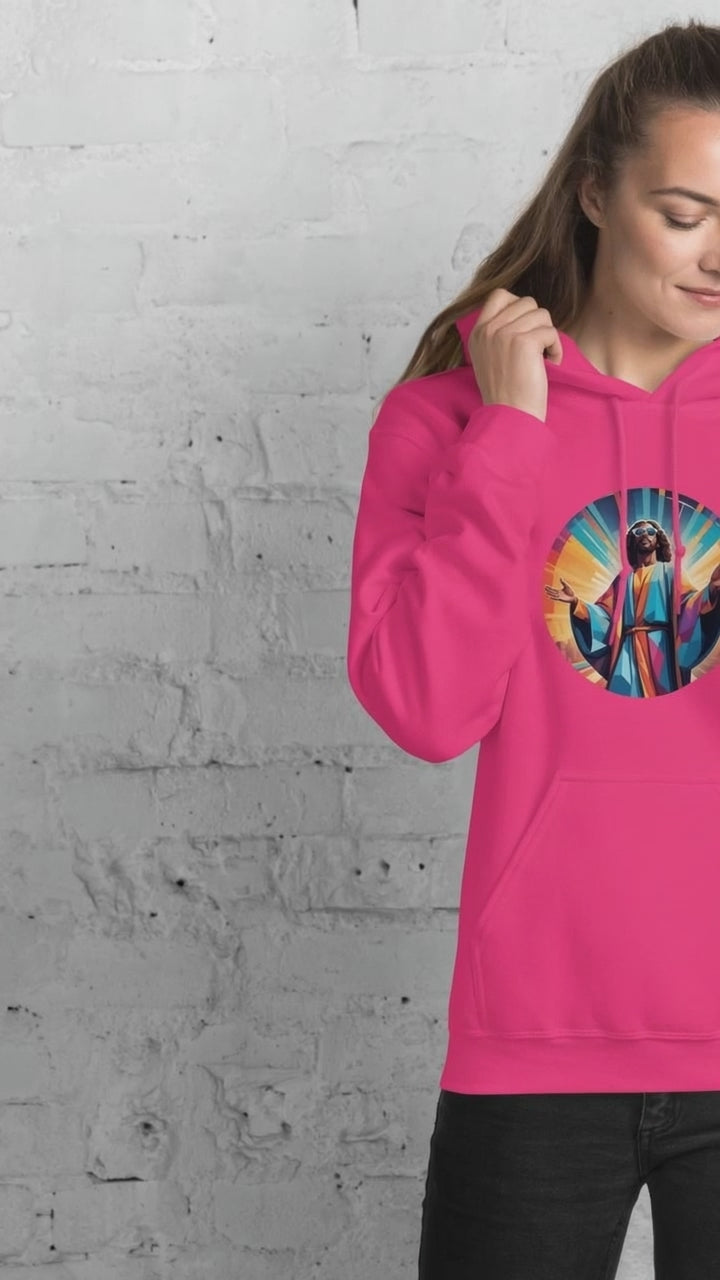 Female model wearing a pink hoodie with a Funky Jaysus graphic on the front and on the wording 'Music is my Religion' text on the back against a white brick wall.