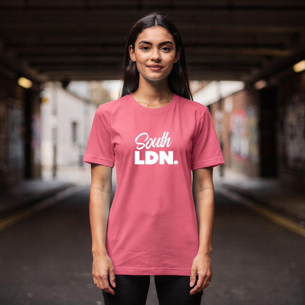 Woman wearing a pink t-shirt with 'South LDN.' text in an urban setting