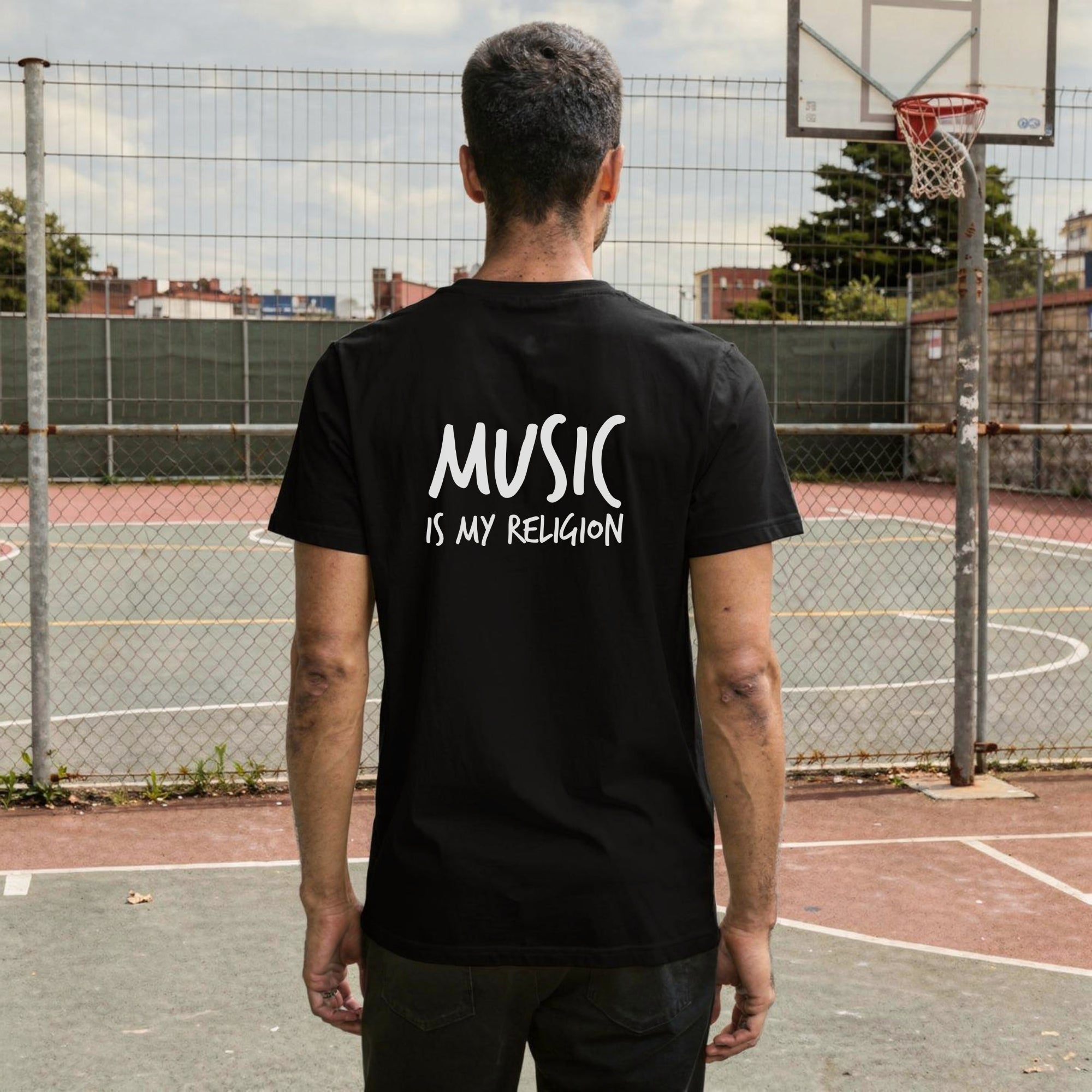 A bold "Music is My Religion" unisex t-shirt featuring a funky Jesus design in vibrant, geometric art. Made from 100% ring-spun cotton, this stylish shirt is perfect for music lovers, festival gear, and unique graphic tees that stand out.
