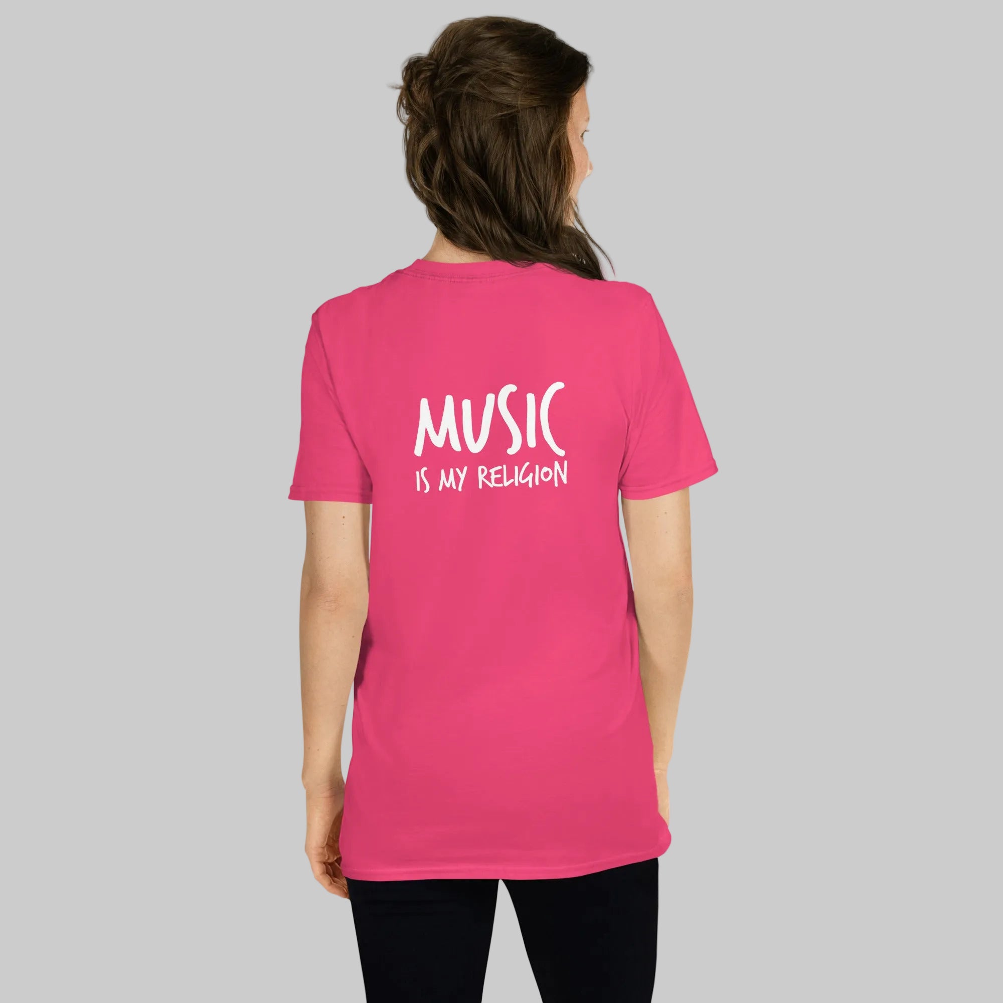 Person wearing a pink t-shirt with 'Music is my Religion' text on the back.