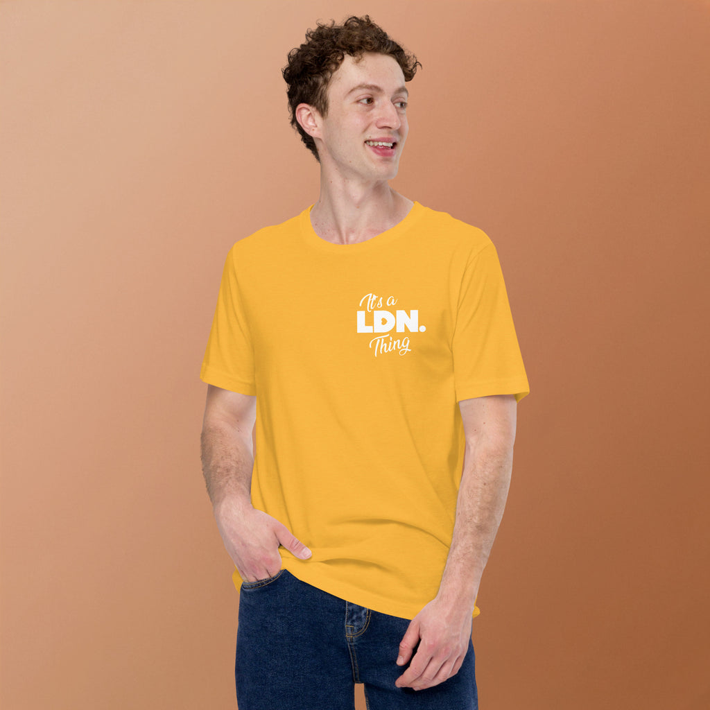 Man wearing a yellow t-shirt with text on a brown background