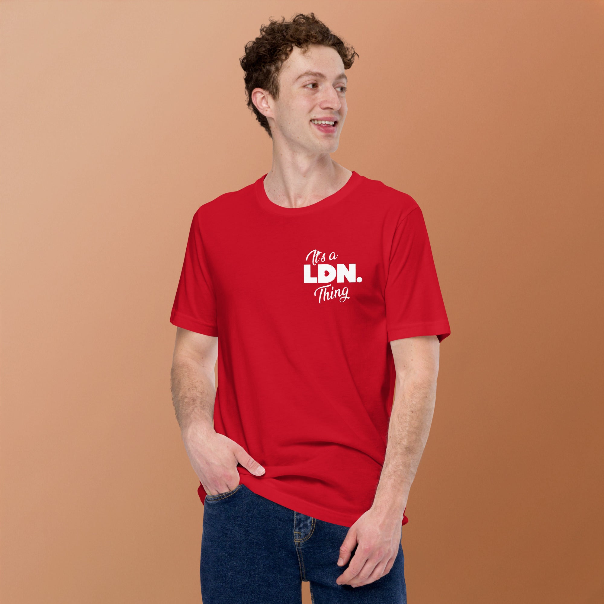 Person wearing a red t-shirt with 'It's a LDN Thing' text on a brown background