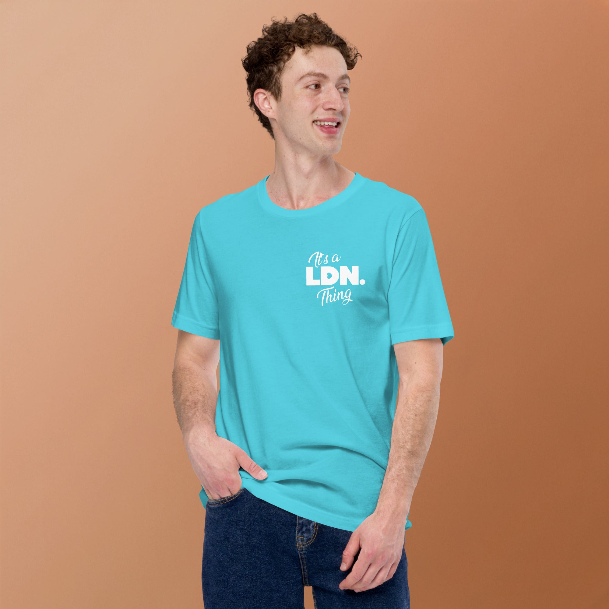Man wearing a turquoise t-shirt with 'It's a LDN thing' text on a brown background