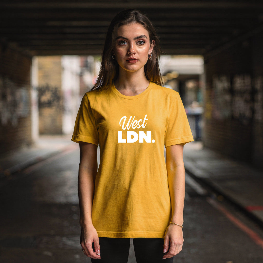 Model wearing a t-shirt with 'West LDN' text, standing in an urban London setting.
