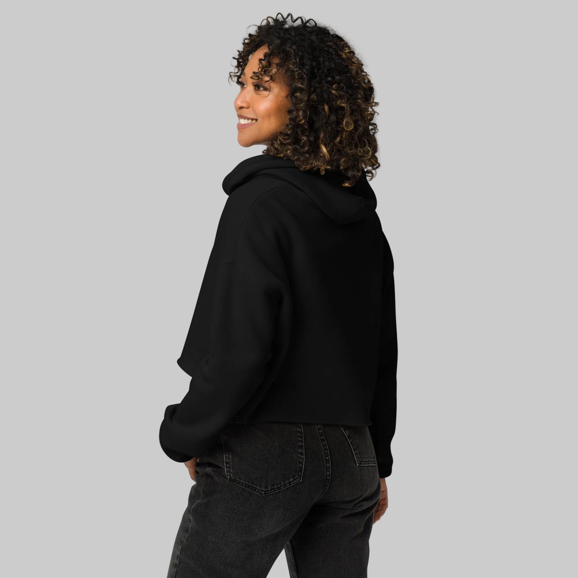 Model wearing a cropped hoodie with tonal “LDN.” graphic. Hoodie features dropped shoulders, raw hem, and dyed-to-match drawstrings. Made from cotton-poly fleece blend for soft comfort and relaxed fit. A minimal, modern streetwear piece.